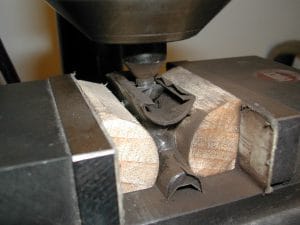 The cutter touching the back of the mortise; ntoe the loosened tape.